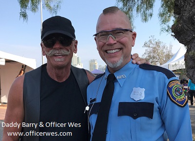 Daddy Barry, Sir, with his boy, Officer Wes at San Diego LGBTQ Pride 2017 in the Leather Realm